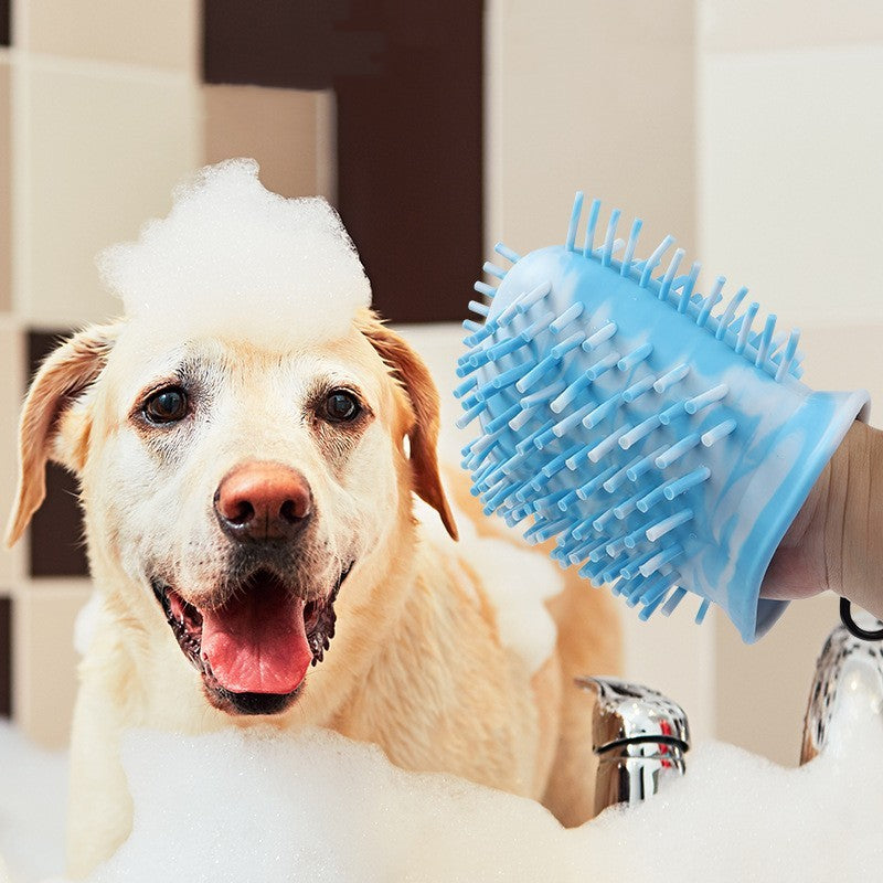 Dog in the bath while the Peluma paw wash cup is used as a grooming brush