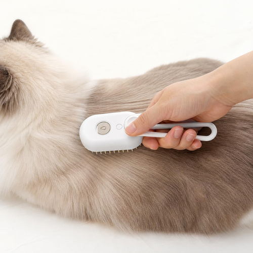The Peluma mist grooming brush being drawn along the coat of a long-haired cat